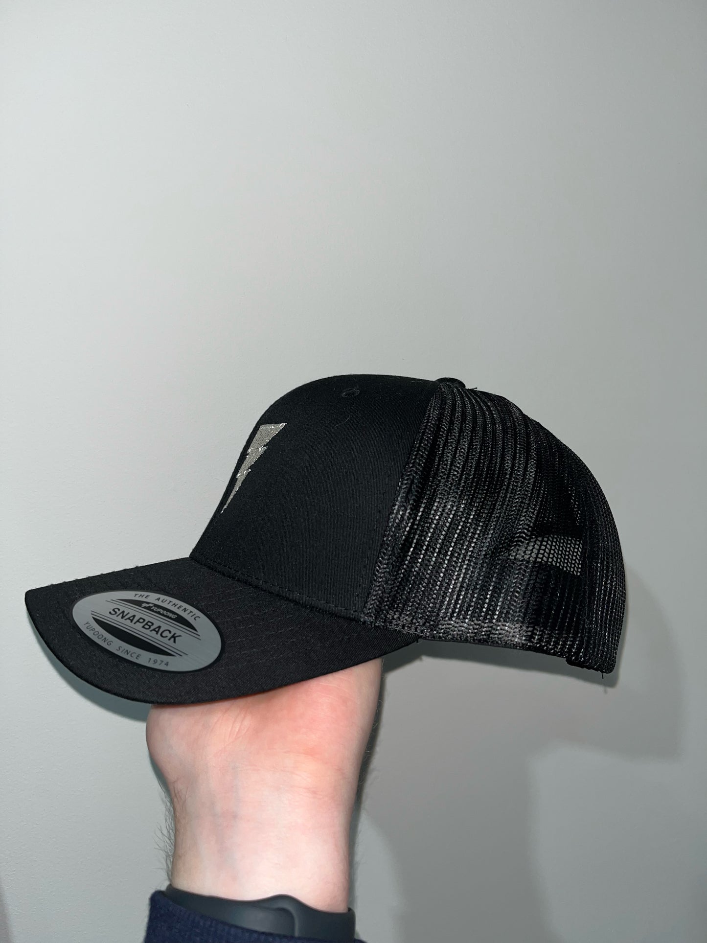 Side View Of Men's Black Metallic Trucker Cap 